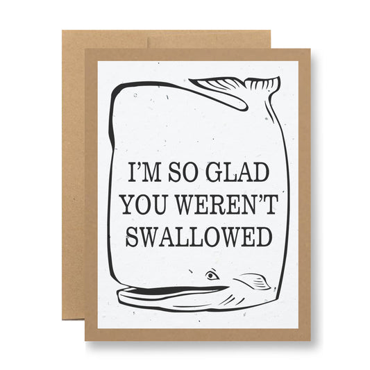 The Plantable Greeting Card - I'm so glad you weren't swallowed by My Store is made from handmade seed paper and showcases a simple whale illustration alongside the bold message, I'M SO GLAD YOU WEREN'T SWALLOWED. It comes with a brown envelope, providing an eco-friendly way to share your heartfelt message.