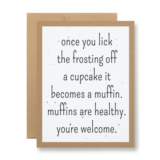 The Plantable Greeting Card - Once you lick the frosting... from My Store features a humorous message: "Once you lick the frosting off a cupcake, it becomes a muffin. Muffins are healthy. You're welcome." This biodegradable card is crafted on handmade seed paper and comes layered atop a brown envelope, ready to bloom wildflowers after use.