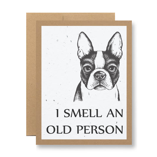 The Plantable Greeting Card - I smell an old person by My Store showcases a Boston Terrier's head on the cover, accompanied by playful text. This charming card comes with a brown envelope and is printed on eco-friendly seed paper that blooms wildflower seeds when planted.