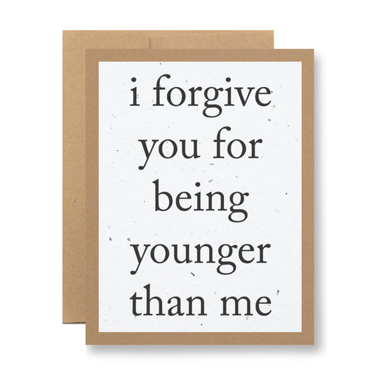 Introducing the Plantable Greeting Card - "I forgive you for being younger than me" by My Store. This charming card showcases a playful message in black text on a minimalist white background, bordered in brown. Made from handmade seed paper, it offers the unique joy of blooming when planted.