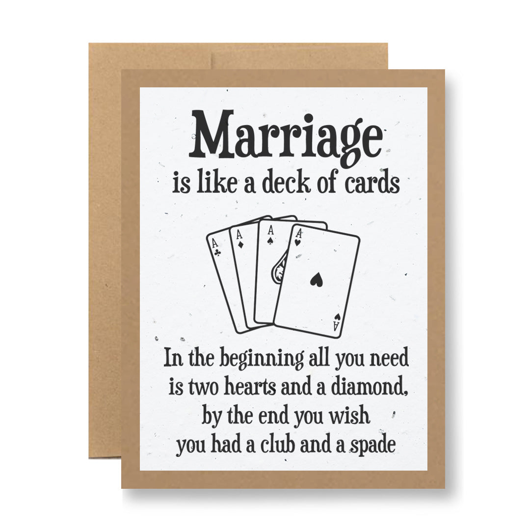 This humorous plantable greeting card about marriage from My Store, titled "Marriage is like a deck of cards...", features a hand-drawn illustration of four playing cards: two hearts, a diamond, a club, and a spade. It’s crafted on recycled cardstock with an eco-friendly touch and set against a light paper texture with a brown envelope.