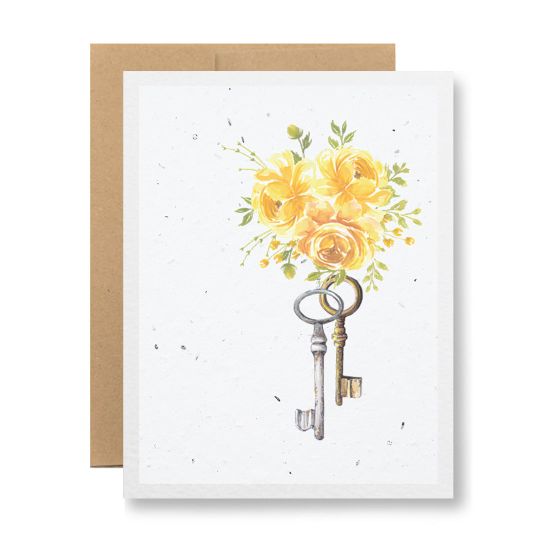 Introducing the Plantable Greeting Card - {keys and flowers} by My Store: A beautifully crafted card made from handmade seed paper. It features a lovely design of yellow roses with keys hanging below, set against a pristine white background. Presented elegantly with a plain brown envelope.