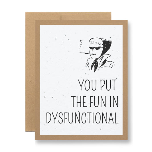 The My Store's Plantable Greeting Card - You put the fun in dysfunctional is designed from wildflower seed-embedded paper. It showcases an illustration of a person wearing sunglasses and a hood, smoking a cigarette, accompanied by the text "YOU PUT THE FUN IN DYSFUNCTIONAL." The card is bordered with brown and features a plain background.