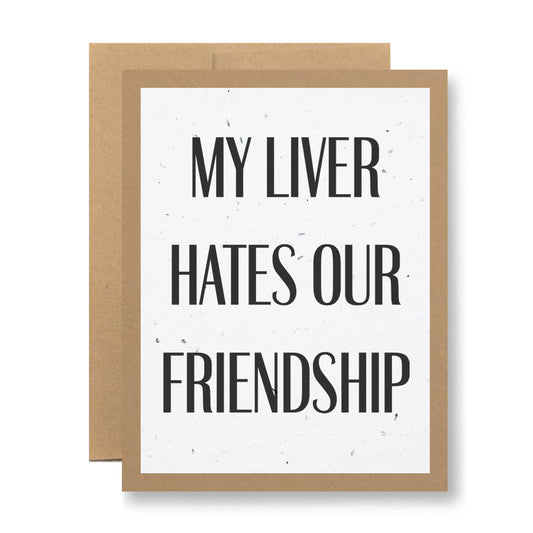 The "My Liver Hates Our Friendship" card from My Store is a humorous greeting card that features bold black text on a white center bordered in brown, likely referencing social drinking habits. Made from biodegradable handmade seed paper with embedded wildflower seeds, the card can be planted to grow flowers.