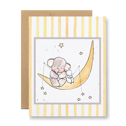 The Plantable Greeting Card - {friends on the moon} by My Store features a handmade illustration of two koalas on a crescent moon. The backdrop includes yellow and white vertical stripes with small stars. A brown envelope, made from eco-friendly seed paper that blooms into wildflowers, accompanies the card.