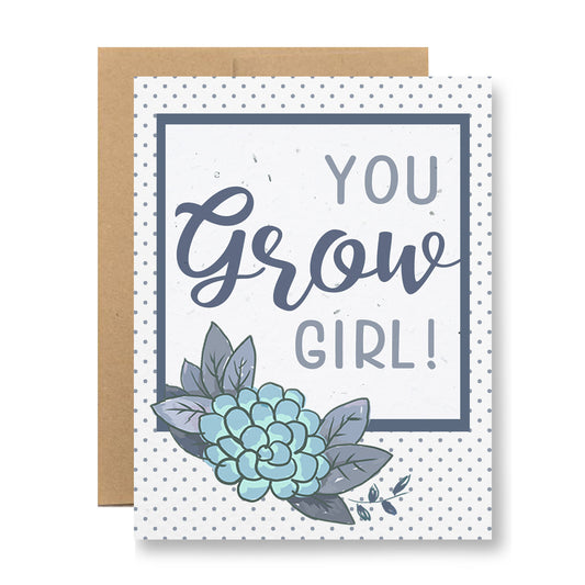 Introducing the Plantable Greeting Card - You grow girl! by My Store: This delightful card features a polka dot background with the spirited message "YOU Grow GIRL!" framed inside a navy border. An adorable illustration of a succulent plant graces the bottom left corner, and its unique handmade seed paper can be planted to sprout wildflower seeds. A simple brown envelope is subtly tucked behind the card.