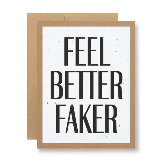 A greeting card from My Store, crafted from recycled cardstock with bold black text on a white background reading "Feel better, faker." It features a brown border and is accompanied by a slightly larger brown card placed behind it.