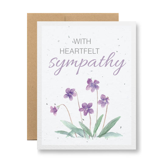 Introducing the "Plantable Greeting Card - With heartfelt sympathy" by My Store. This sympathy card comes with a brown envelope and is crafted from handmade seed paper. It showcases beautiful watercolor violets alongside the message "With heartfelt sympathy" in elegant purple and grey text. As you honor your loved one's memory, you can also plant wildflower seeds, enjoying the eco-friendly touch of this biodegradable card.