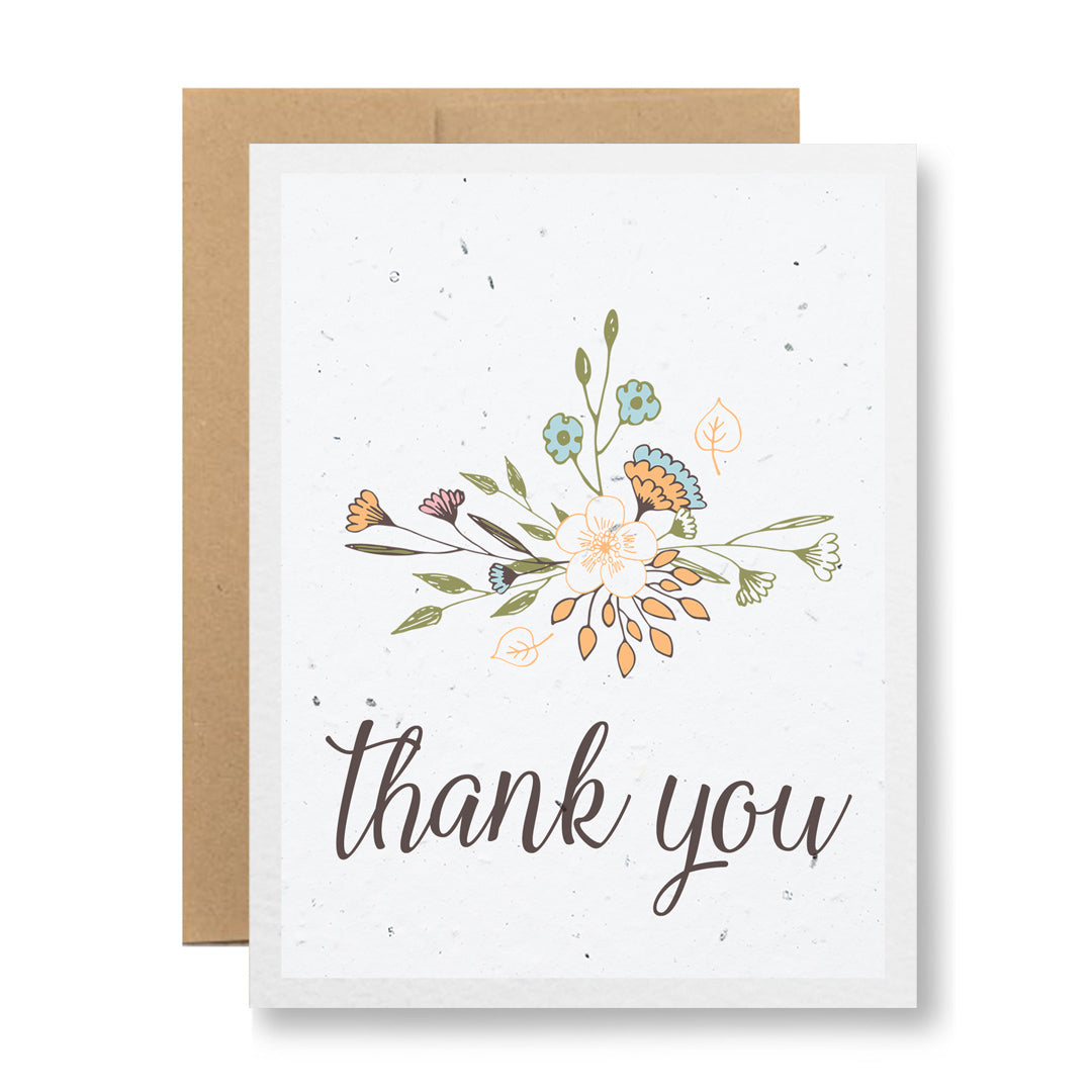 A heartfelt thank you card from My Store's Plantable Greeting Card - Thank You {floral sketch} collection, made from biodegradable materials with delicate pastel floral designs and an elegant "thank you" script. This eco-friendly memento comes with a matching brown envelope.