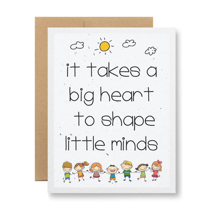 The "Plantable Greeting Card - It takes a big heart..." by My Store is made from biodegradable, handmade seed paper and showcases an illustration of nine smiling children holding hands at the bottom. The card features the message, "It takes a big heart to shape little minds," with a sun and clouds above that will sprout wildflower seeds when planted.